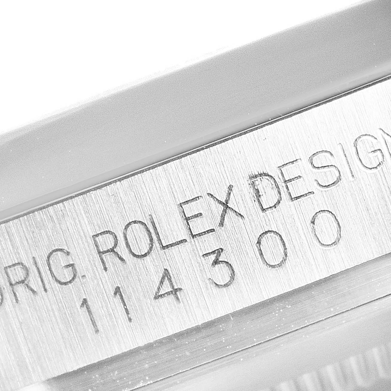 This image shows a close-up of the model number "114300" etched on the side of the Rolex Oyster Perpetual 114300 Men's Stainless Steel Grey Dial 114300 Men's Stainless Steel Grey Dial watch case.