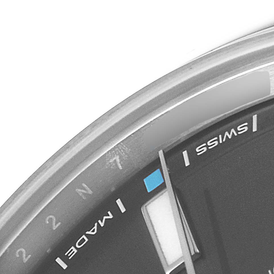 The image shows a close-up of the dial and bezel of a Rolex Oyster Perpetual 114300 Men's Stainless Steel Grey Dial 114300 Men's Stainless Steel Grey Dial watch, highlighting the "SWISS MADE" text and indices.