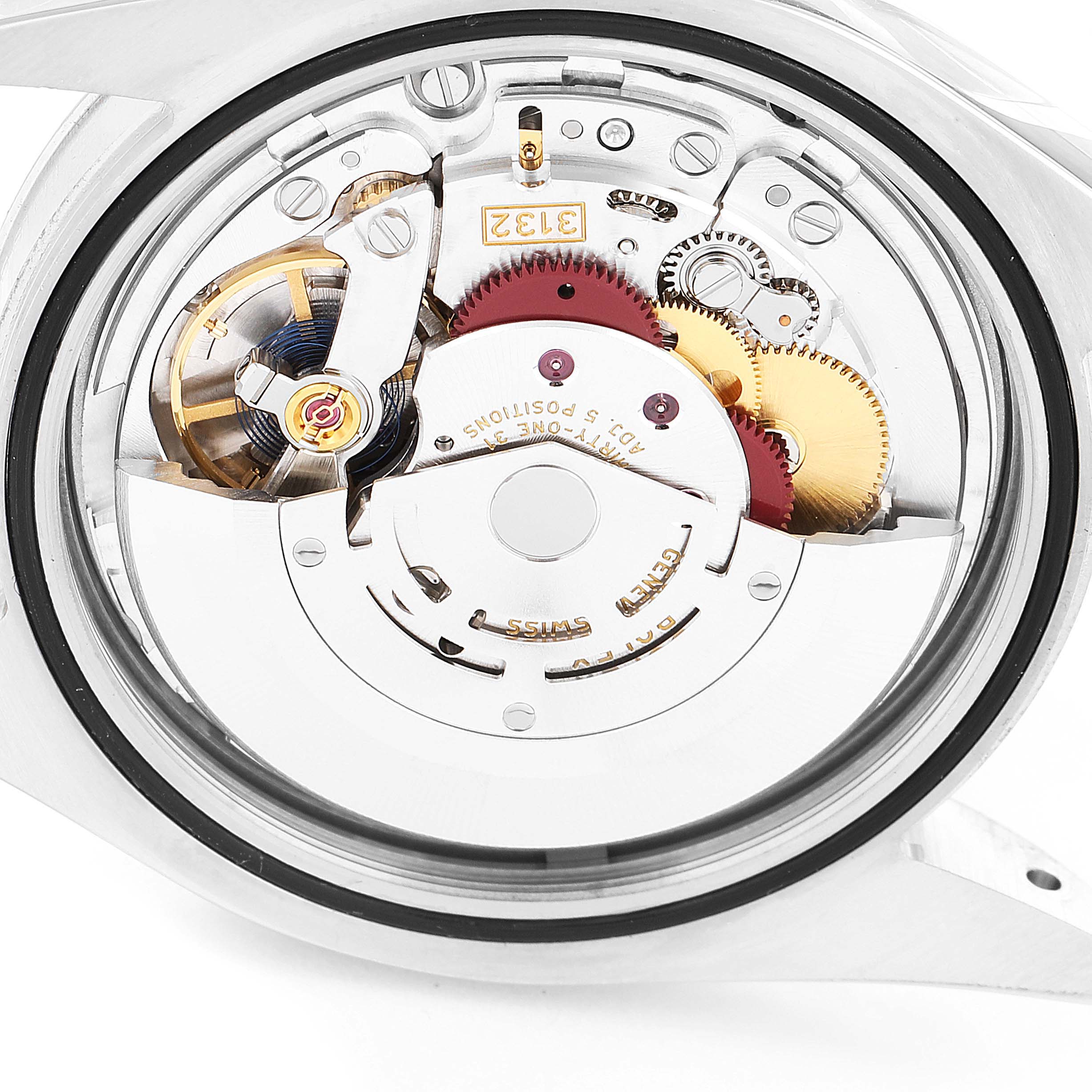 The image shows a close-up, rear view of the movement mechanism inside a Rolex Oyster Perpetual 114300 Men's Stainless Steel Grey Dial 114300 Men's Stainless Steel Grey Dial watch case.