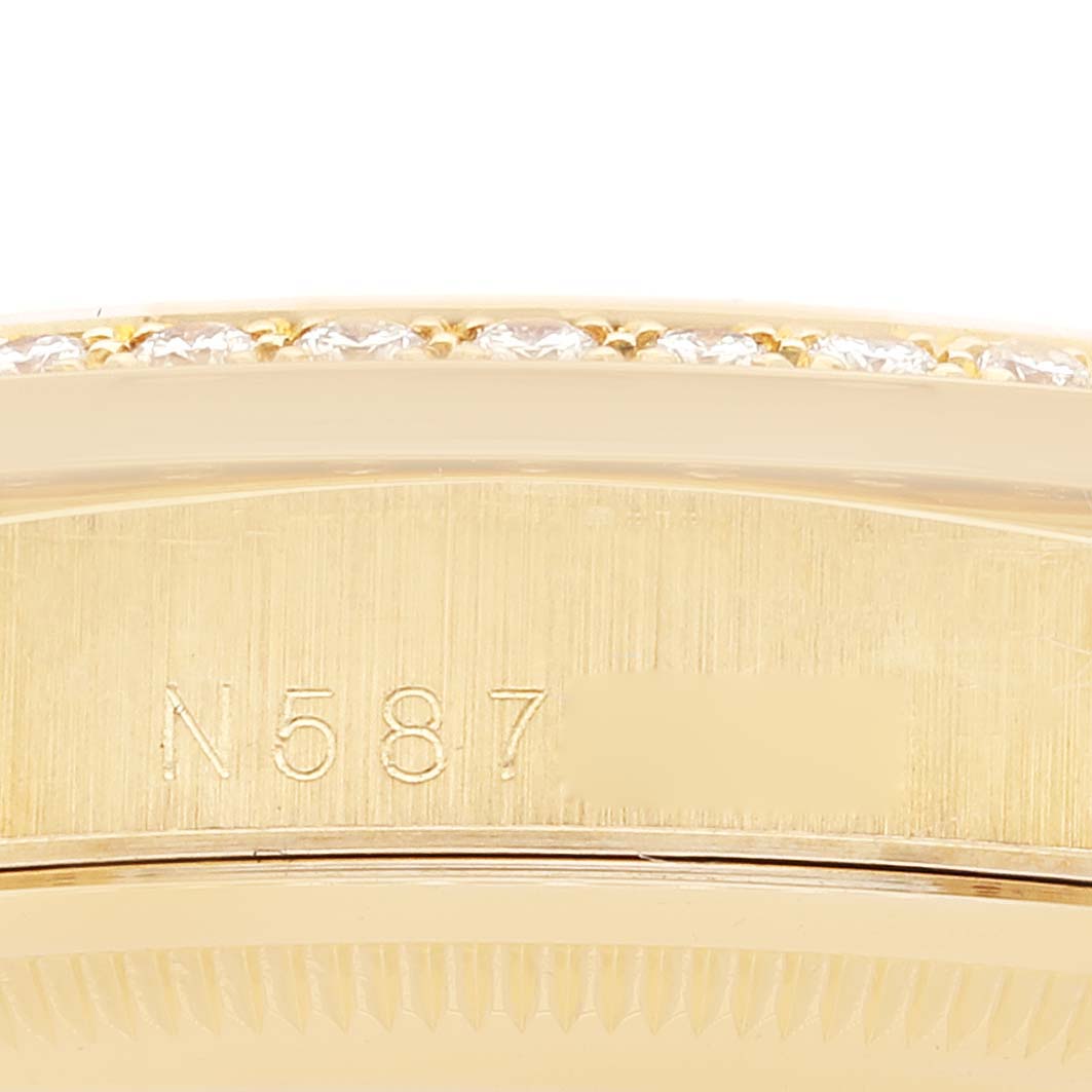 This close-up image shows the engraved serial number on the side of the Rolex President 18388 Men
s Yellow Gold Champagne Dial 18388 Men
s Yellow Gold Champagne Dial model watch, along with part of the bezel.