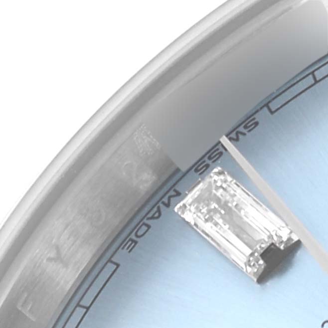 The image shows a close-up of the Rolex President 228206 Men's Platinum Blue Dial 228206 Men's Platinum Blue Dial watch face, highlighting the bezel, part of the dial, and a diamond marker.