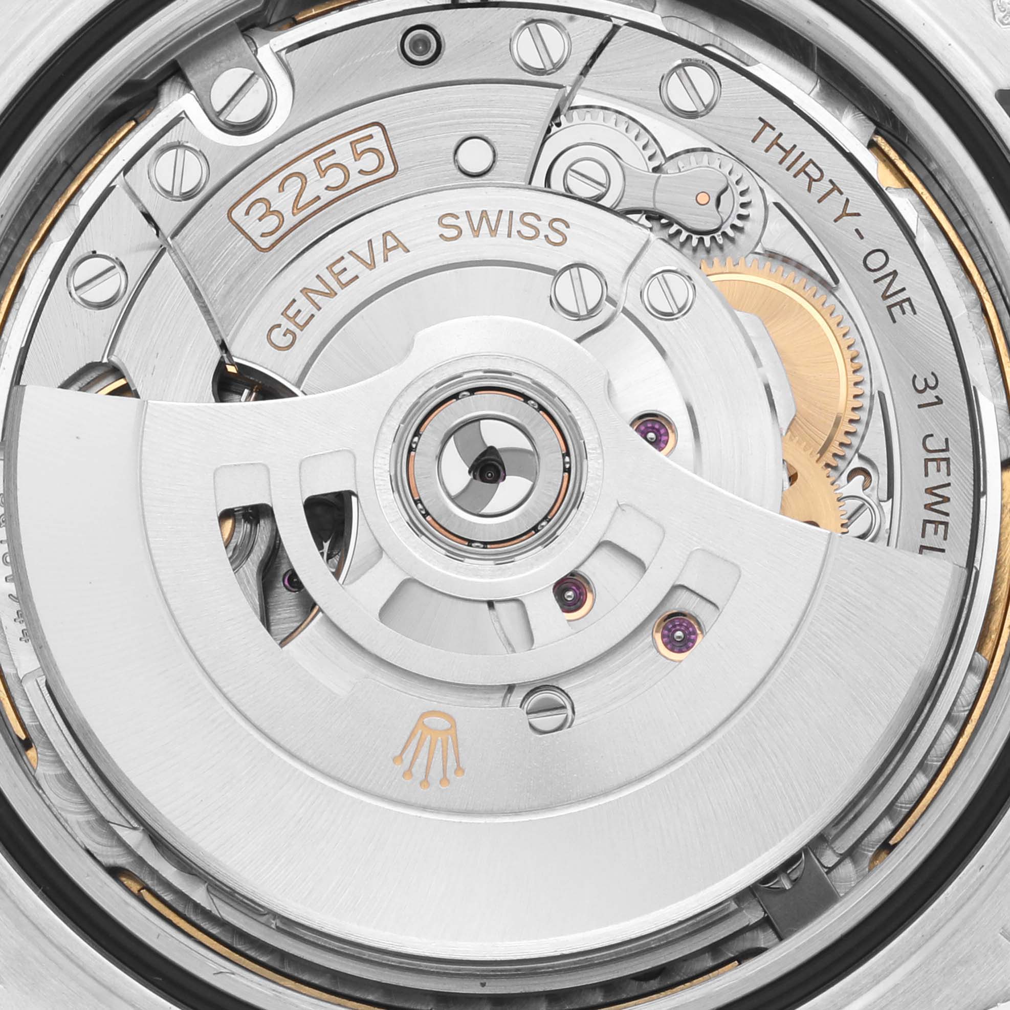 The image shows the inner movement of a Rolex President 228206 Men's Platinum Blue Dial 228206 Men's Platinum Blue Dial model, highlighting gears and the rotor from an overhead angle.