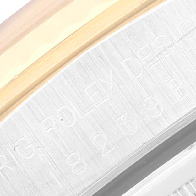 The image shows a close-up of the side of a Rolex President 18239 Men's White Gold Champagne Dial 18239 Men's White Gold Champagne Dial watch, specifically focusing on the engraved text on the case and the edge of the bezel.