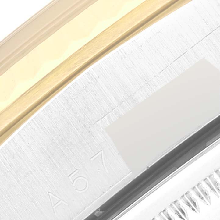 The image shows a close-up of the Rolex President 18239 Men's White Gold Champagne Dial 18239 Men's White Gold Champagne Dial model's metal edge and bezel, highlighting gold and steel segments and the marking "A57".