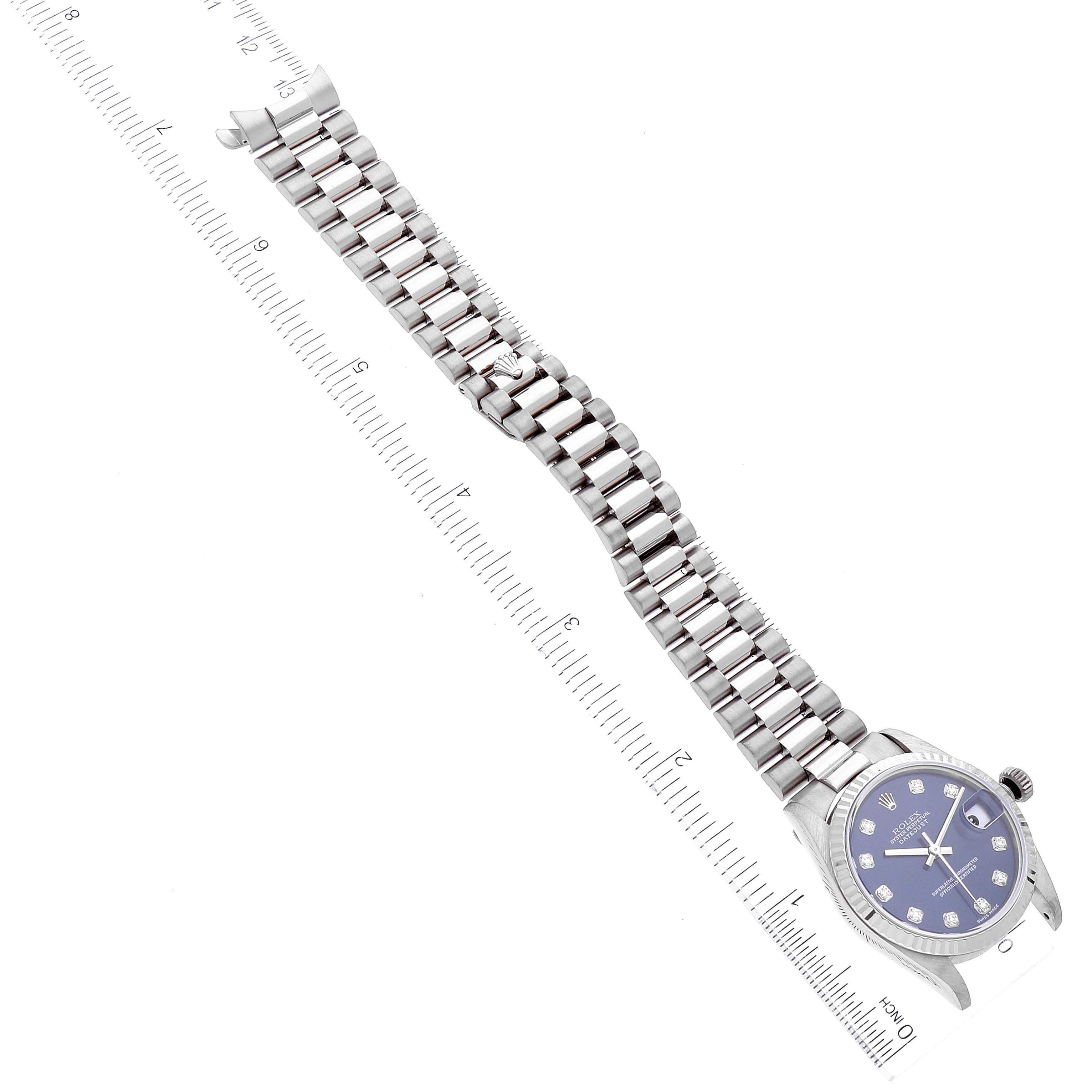The image shows a top-down view of a Rolex President 78279 Women's White Gold Blue Dial 78279 Women's White Gold Blue Dial model watch, highlighting its bracelet, dial, and case.