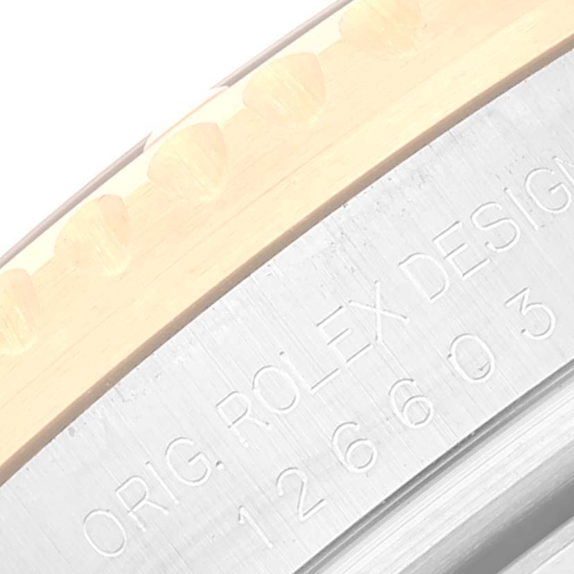 This close-up image shows the bezel and the engraved part of the case back of a Rolex Sea-Dweller 126603 Men's Steel and Gold (two tone) Black Dial 126603 Men's Steel and Gold (two tone) Black Dial watch.