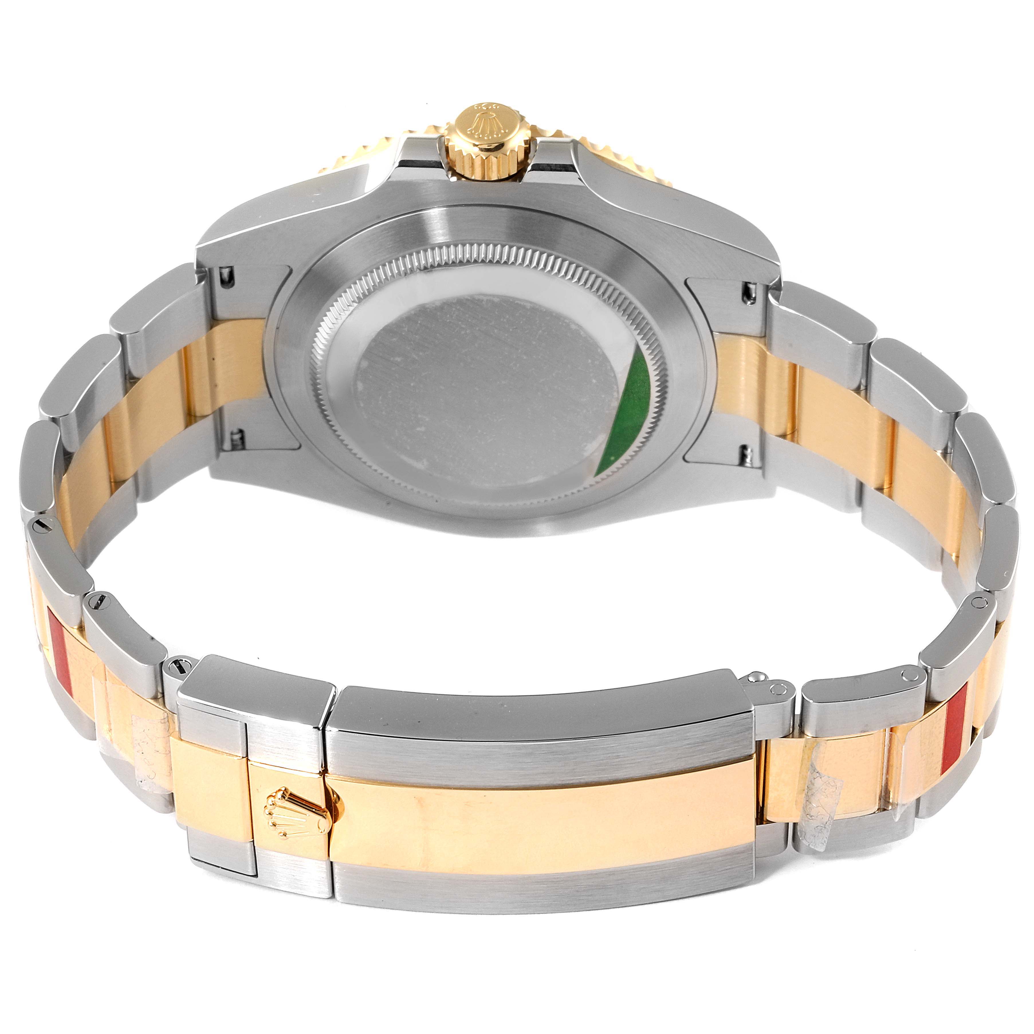 The image shows the back case and bracelet of a Rolex Submariner 126613 Men's Steel and Gold (two tone) Black Dial 126613 Men's Steel and Gold (two tone) Black Dial watch, highlighting its gold and silver color scheme.