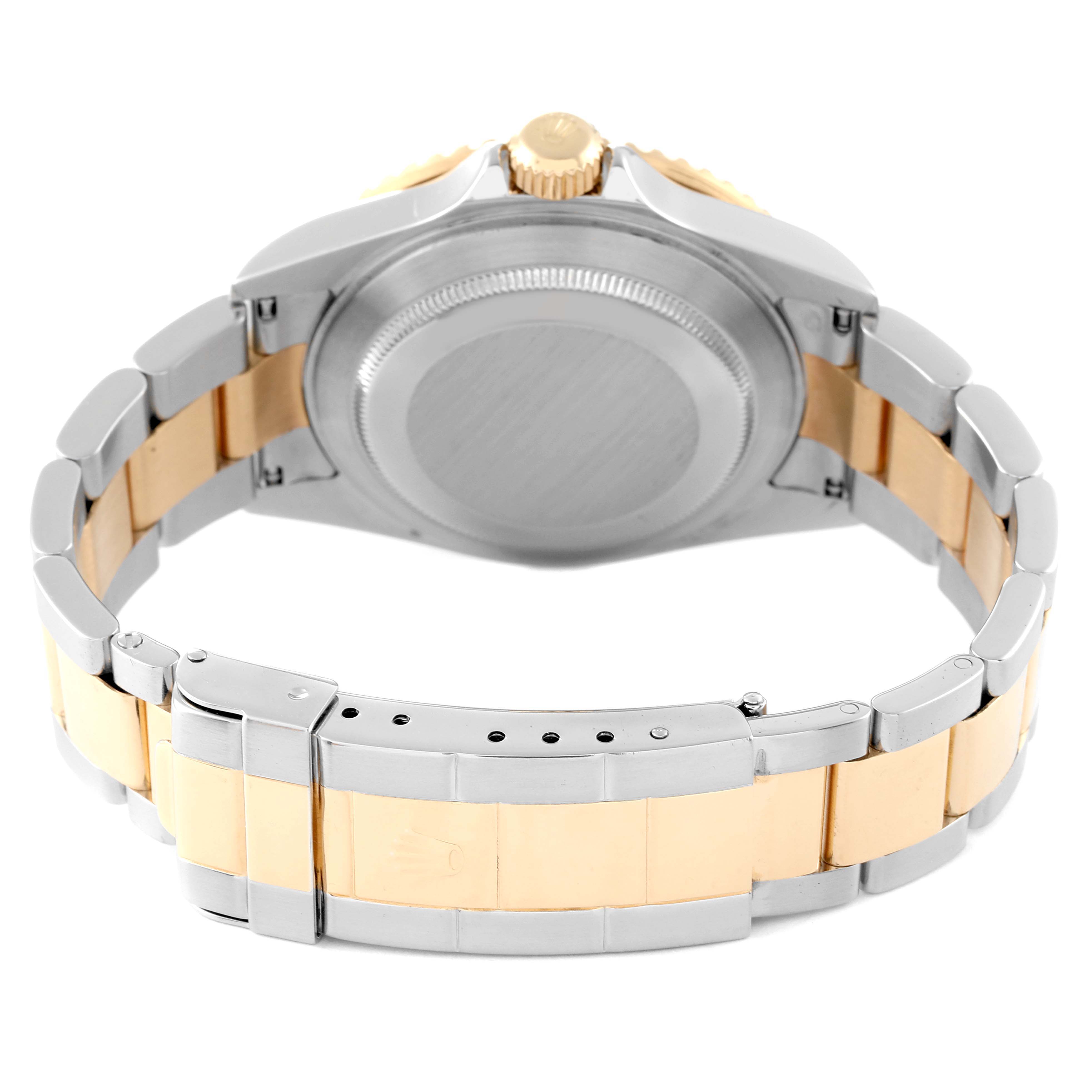 The image shows the back view of a Rolex Submariner 16613 Men's Steel and Gold (two tone) Blue Dial 16613 Men's Steel and Gold (two tone) Blue Dial watch, highlighting its case, crown, and two-tone bracelet.