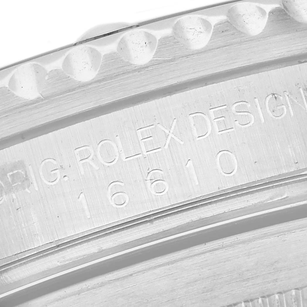 The image shows a close-up of the engraved case edge of a Rolex Submariner 16610 Men
s Stainless Steel Black Dial 16610 Men
s Stainless Steel Black Dial.