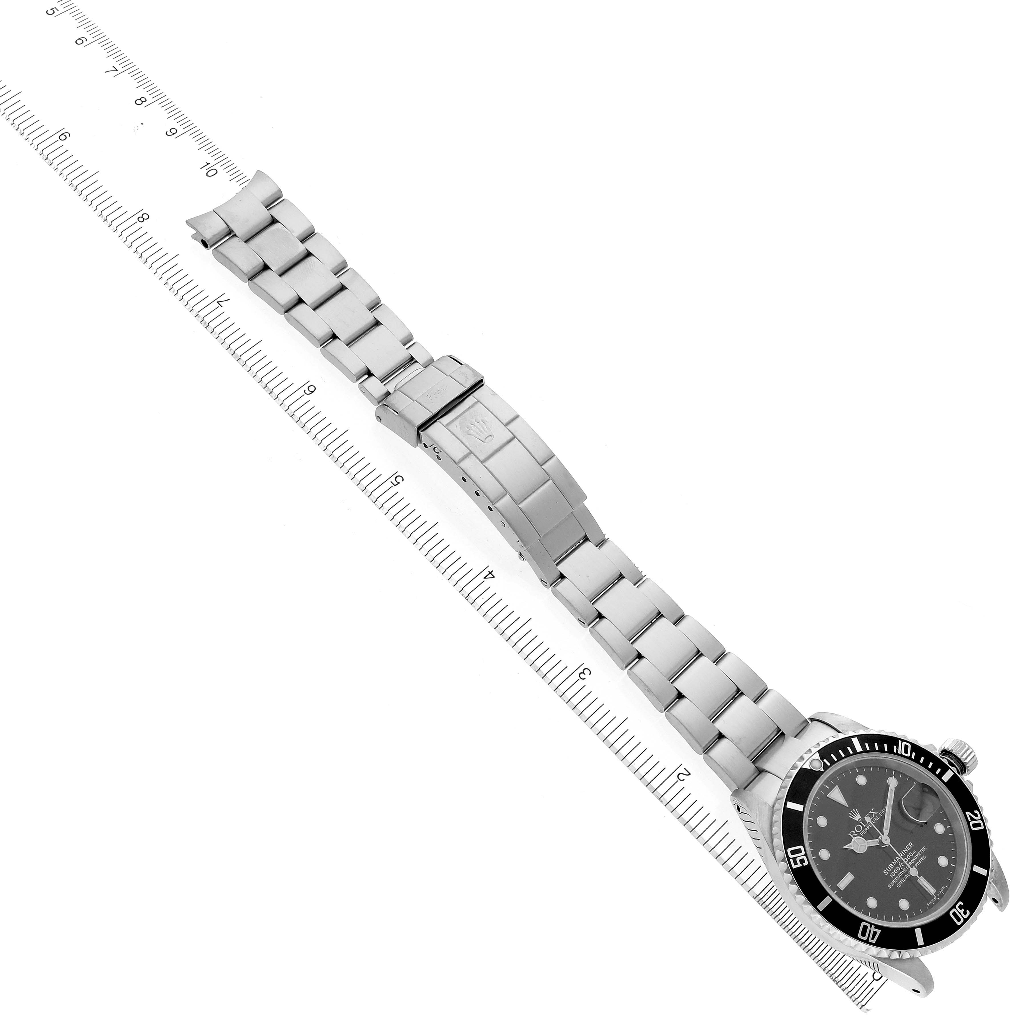 The image shows a Rolex Submariner 16610 Men
s Stainless Steel Black Dial 16610 Men
s Stainless Steel Black Dial from a top-down angle, featuring the watch face, bezel, bracelet, and clasp.