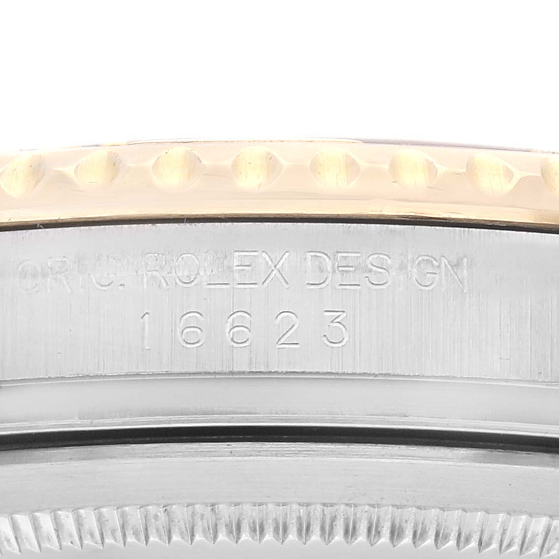 This image shows a close-up view of the bezel and side of the case of a Rolex Yacht-Master 16623 Men
s Steel and Gold (two tone) Silver Dial 16623 Men
s Steel and Gold (two tone) Silver Dial watch, featuring engraved text and the model number 16623.