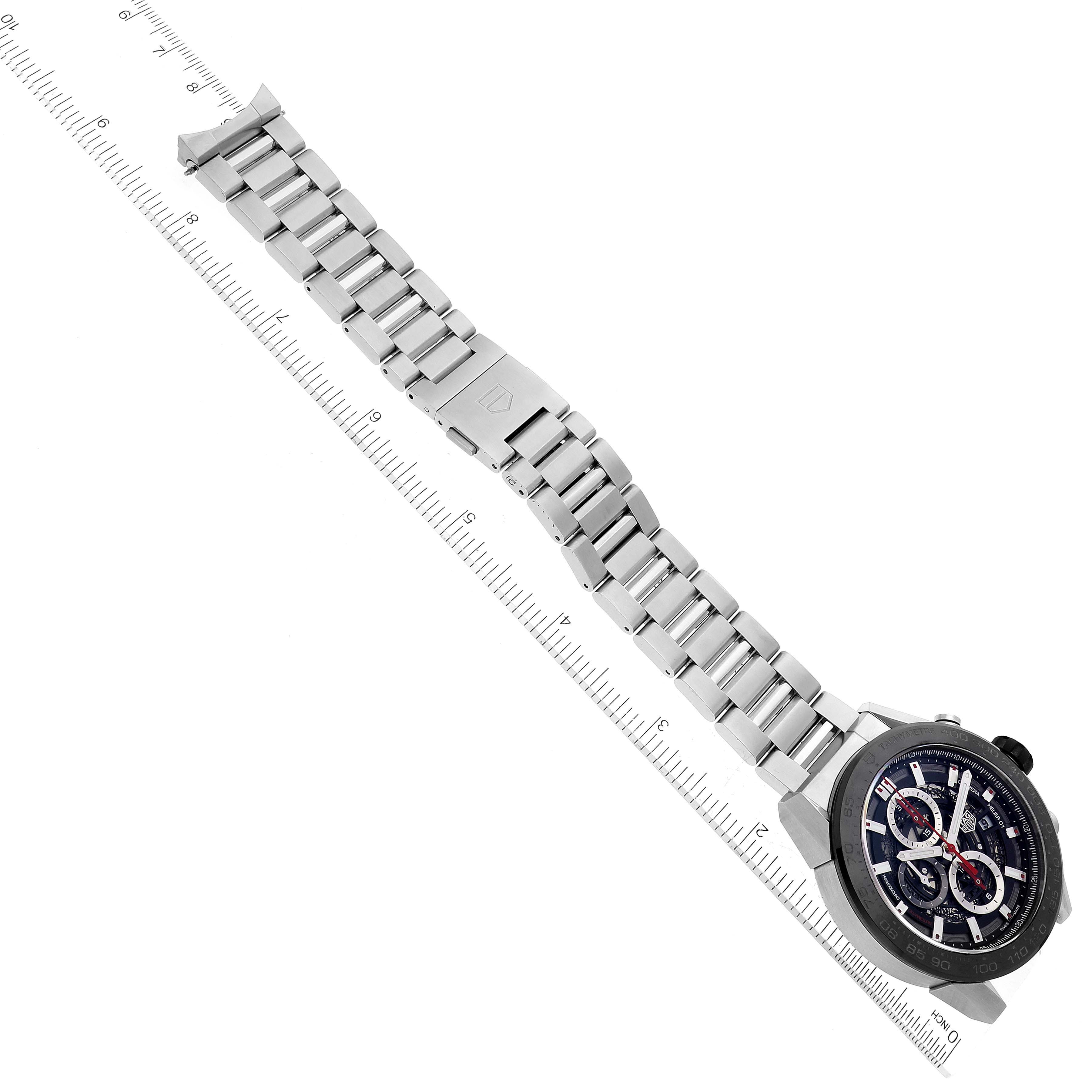 The image shows a Tag Heuer Carrera CAR2A1W Men
s Stainless Steel Transparent Dial CAR2A1W Men
s Stainless Steel Transparent Dial watch laid flat with its stainless steel bracelet extended beside a ruler for scale.