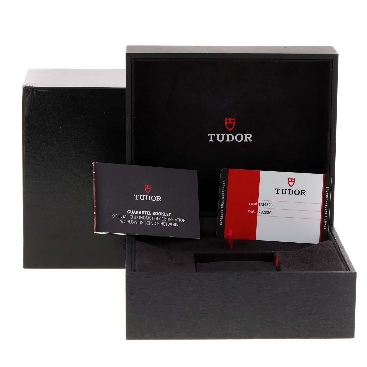 The image shows the Heritage Black Bay
s Tudor packaging with a guarantee booklet and warranty card inside the box.
