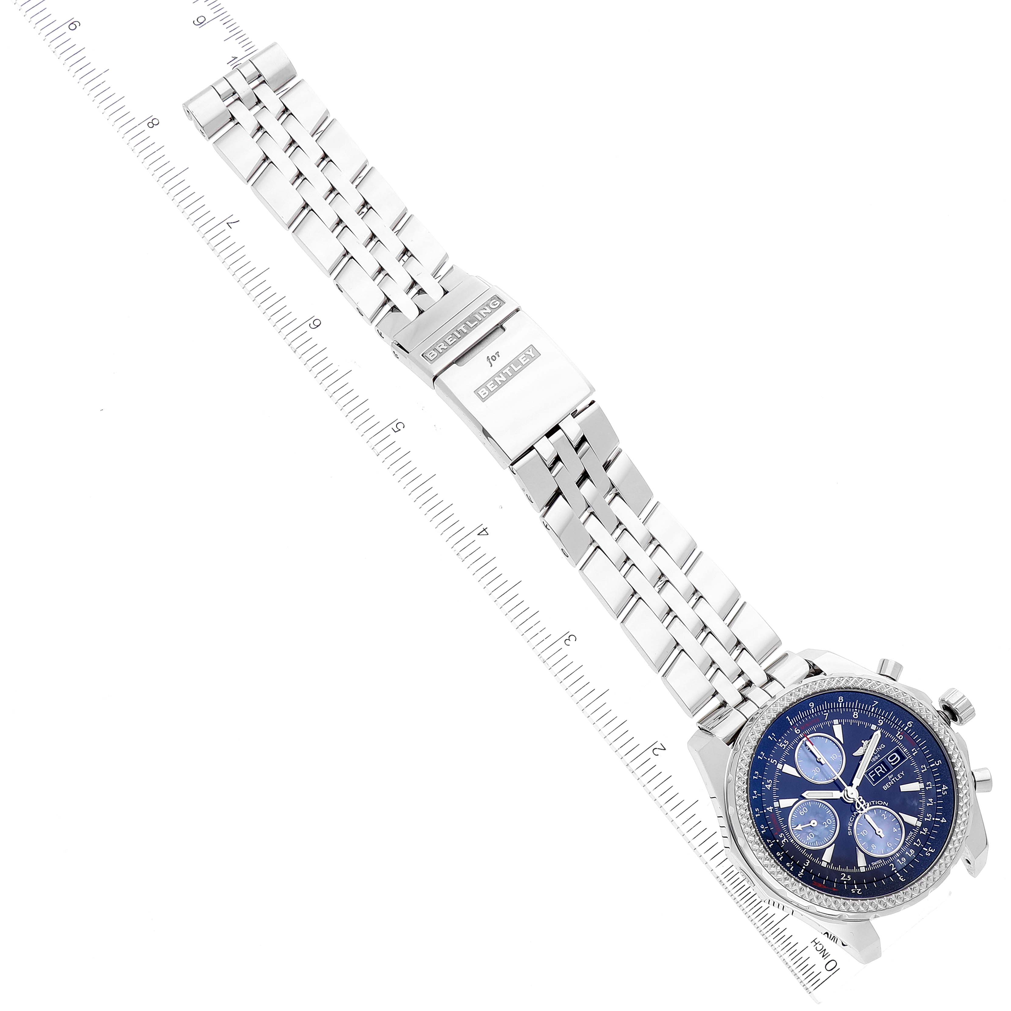 The image shows a top view of a Bentley model by Breitling, showcasing its metal bracelet and blue chronograph dial with a ruler for scale.