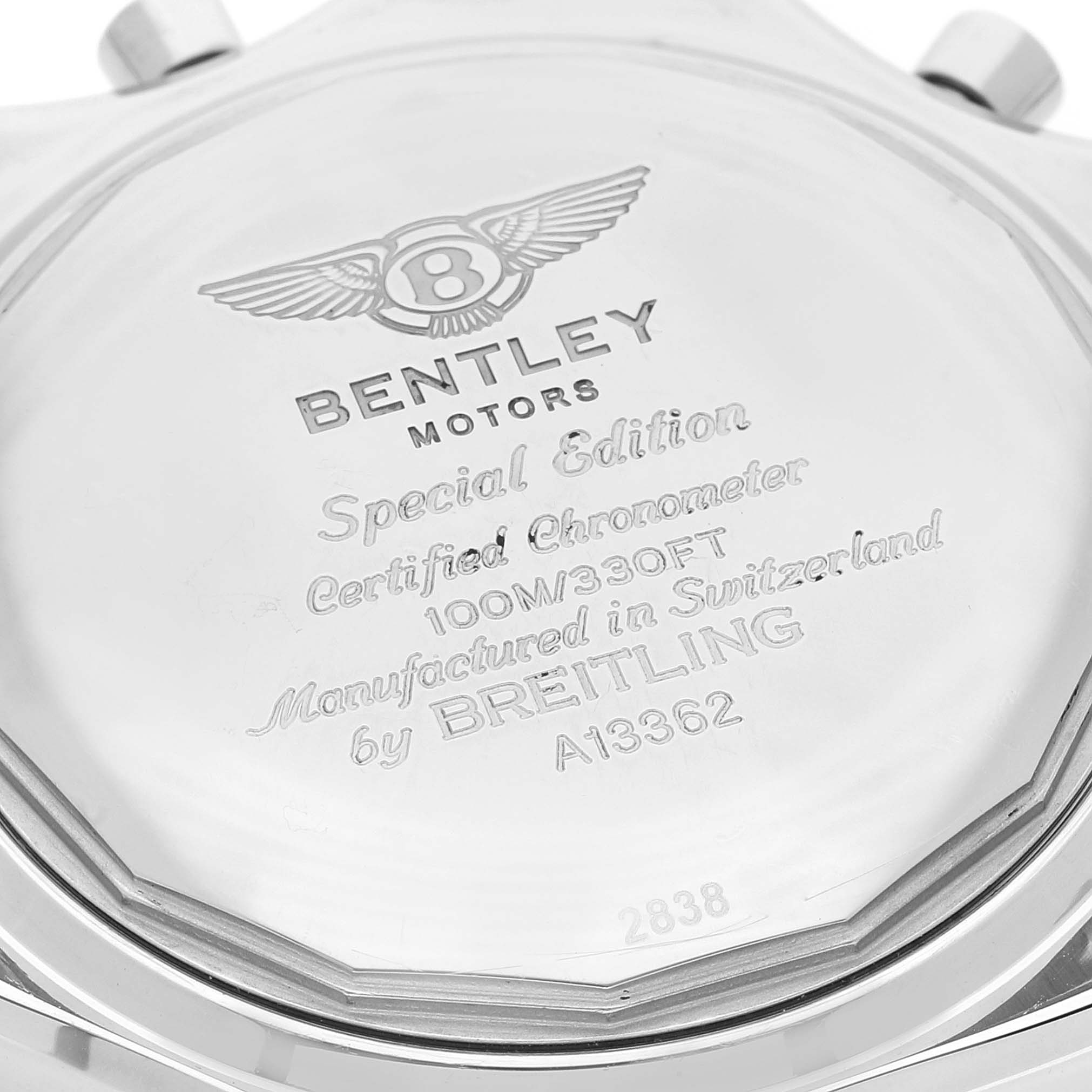 This is a close-up image of the back case of a Bentley model watch by Breitling, displaying its engravings and logo.