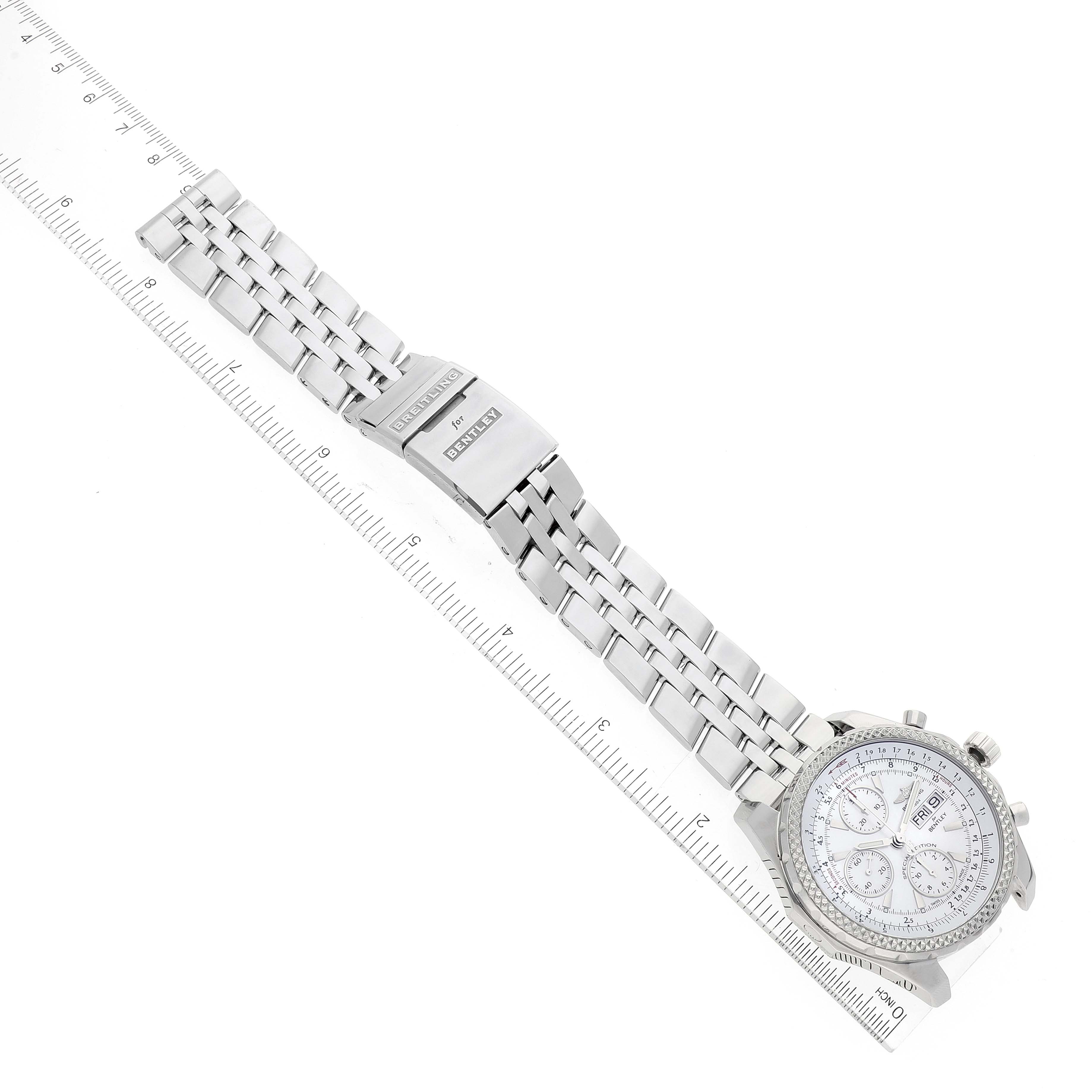 The image shows a Breitling Bentley A13362 Men's Stainless Steel Mother of Pearl Dial A13362 Men's Stainless Steel Mother of Pearl Dial watch lying flat with its metal strap extended next to a ruler for scale.