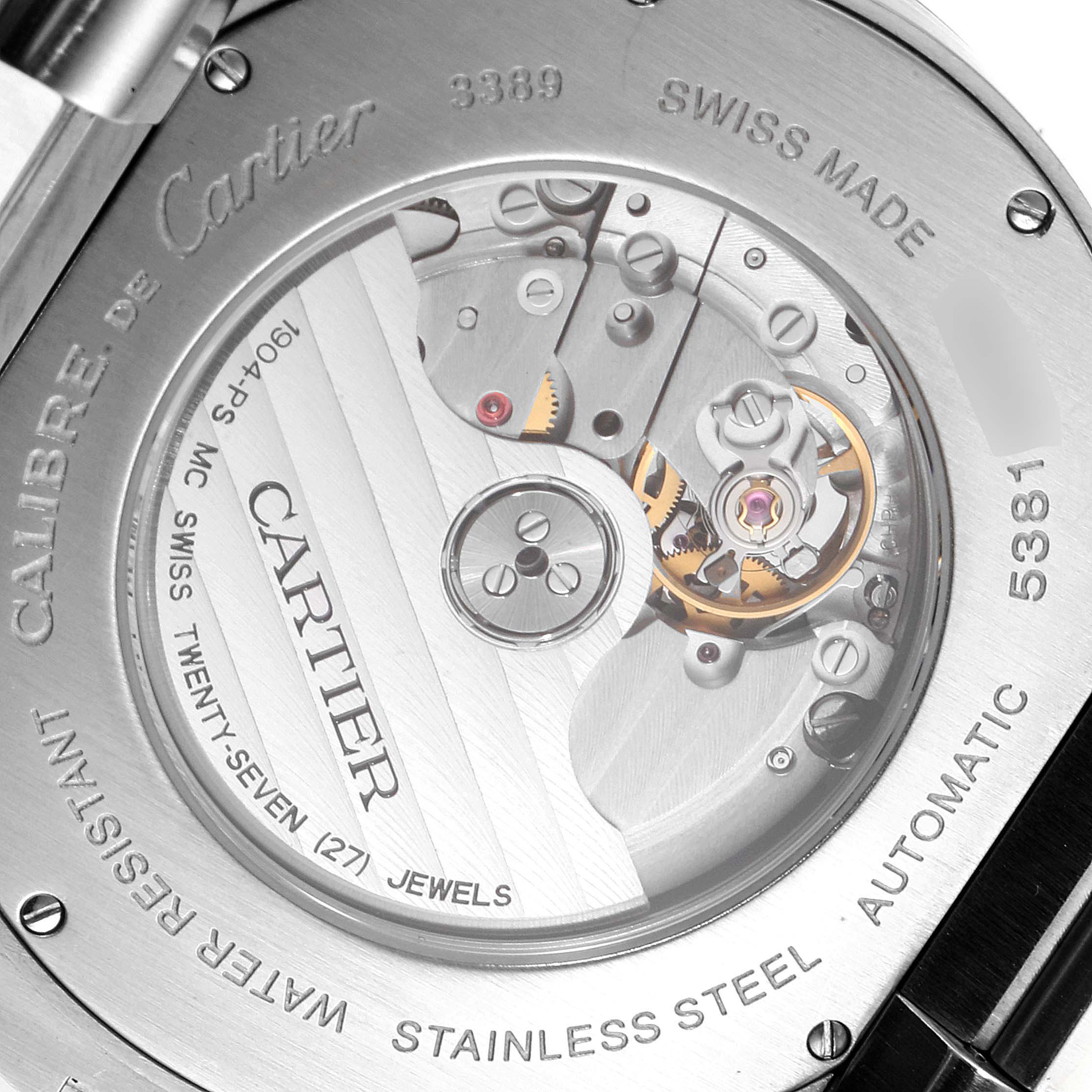 This image shows the back view of the Calibre de Cartier watch by Cartier, displaying the inner movement and engravings.