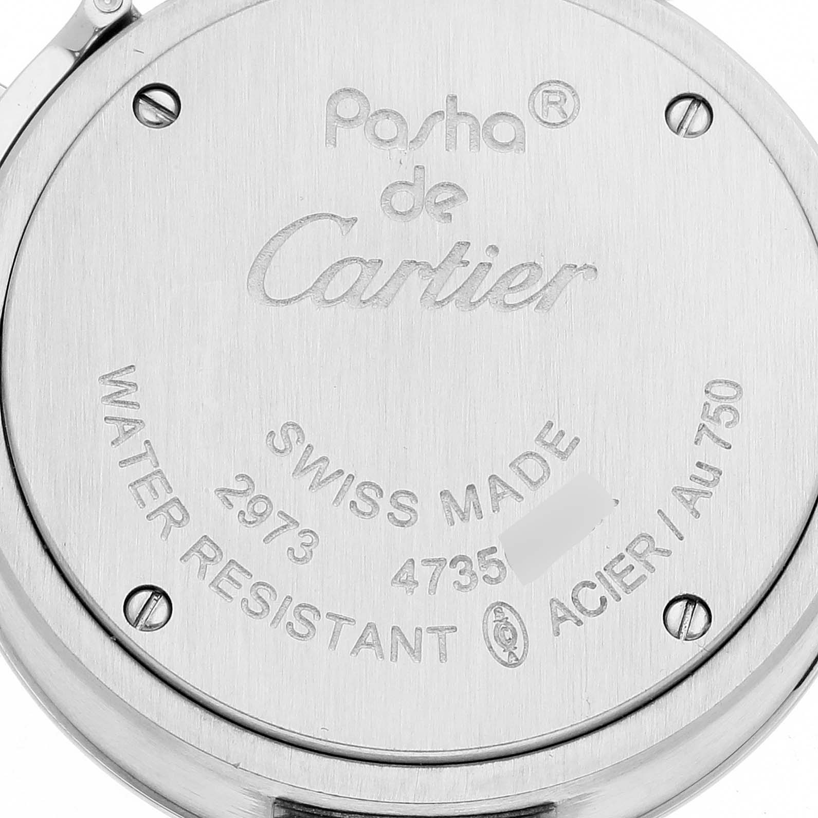 This image shows the back casing of a Pasha de Cartier watch, highlighting inscriptions and screws.