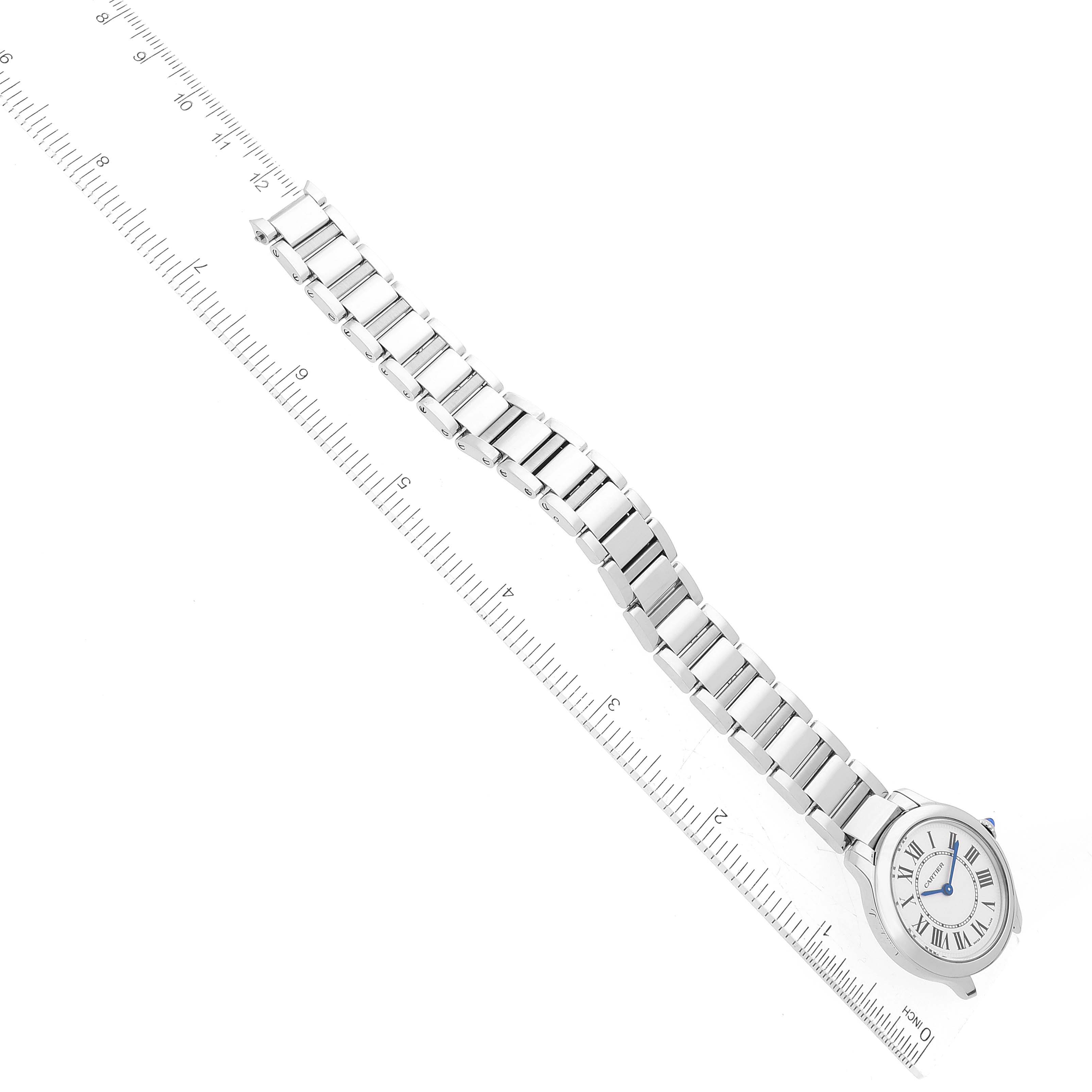 The image shows a top view of the Cartier Ronde WSRN0033 Women's Stainless Steel Silver Dial WSRN0033 Women's Stainless Steel Silver Dial watch, showcasing its face and metal link bracelet aligned next to a ruler for scale.
