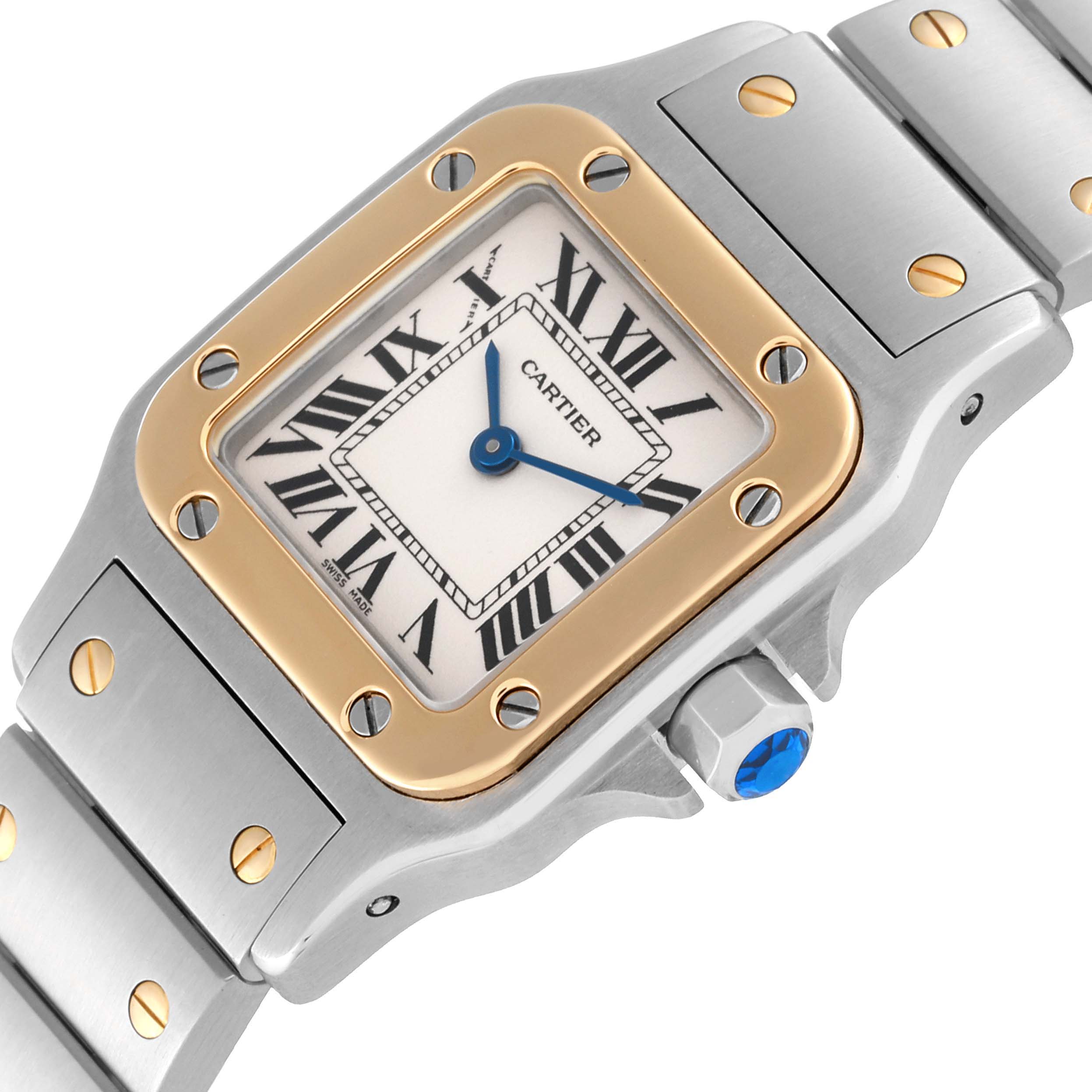 This image shows a close-up of the Cartier Santos W20012C4 Women's Steel and Gold (two tone) Silver Dial W20012C4 Women's Steel and Gold (two tone) Silver Dial watch, highlighting the dial, bezel, bracelet, and crown.