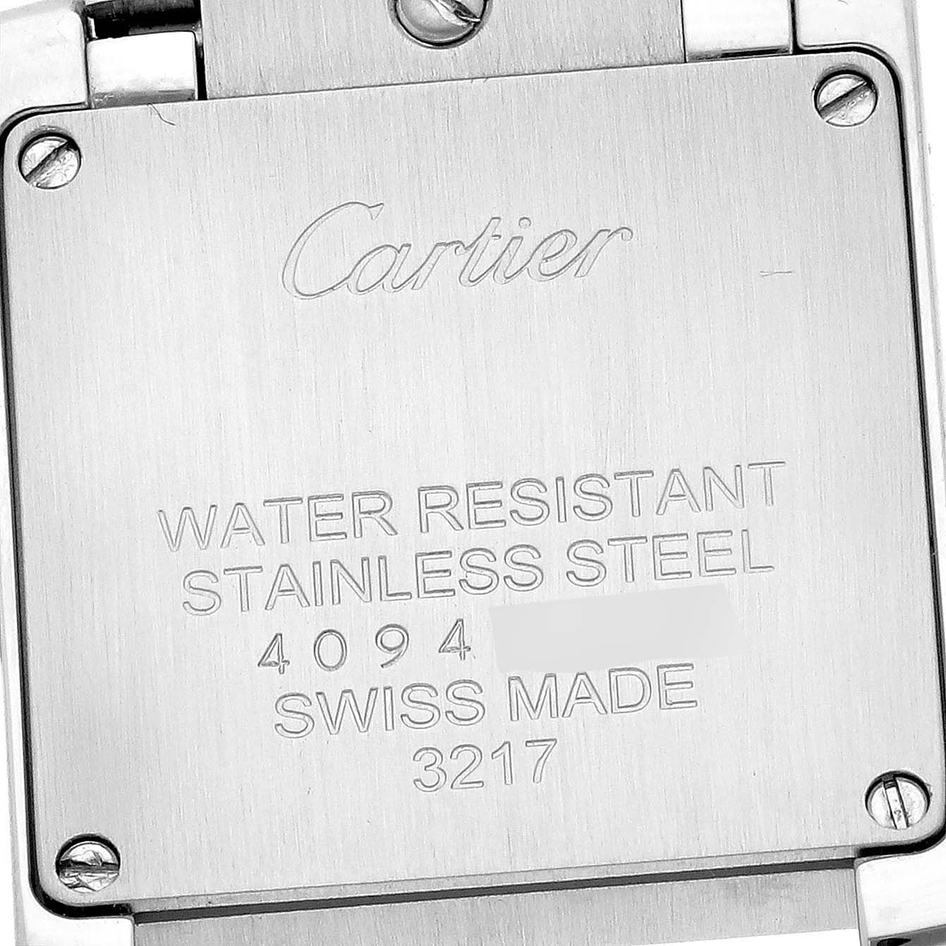 The image shows the back case of the Cartier Tank Française watch, highlighting its engraving details.