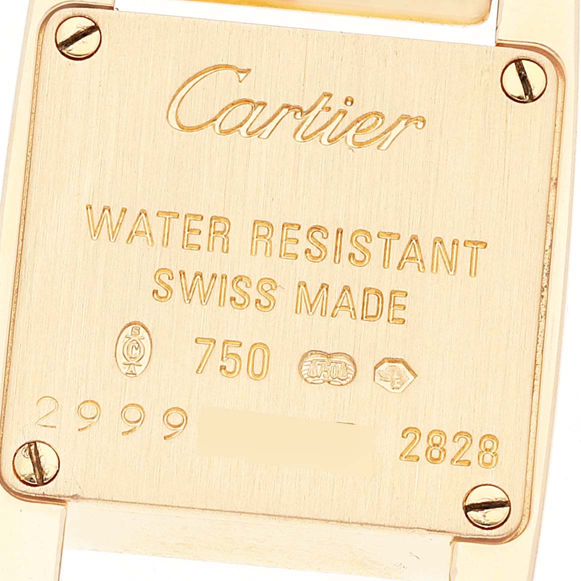 This image shows the back case of a Cartier Tankissime W650037H Women
s Yellow Gold Silver Dial W650037H Women
s Yellow Gold Silver Dial watch, displaying engravings and screws.