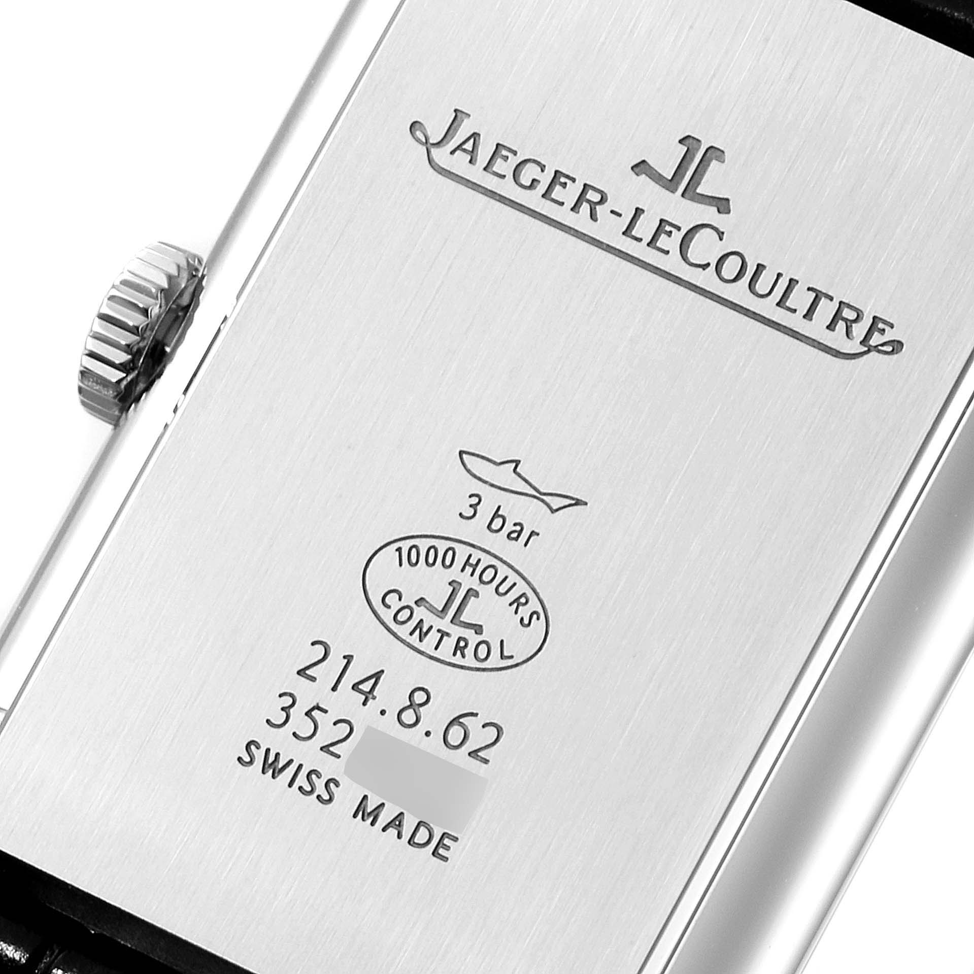 This image shows the back of a Jaeger-LeCoultre Reverso watch, highlighting its engravings and crown.
