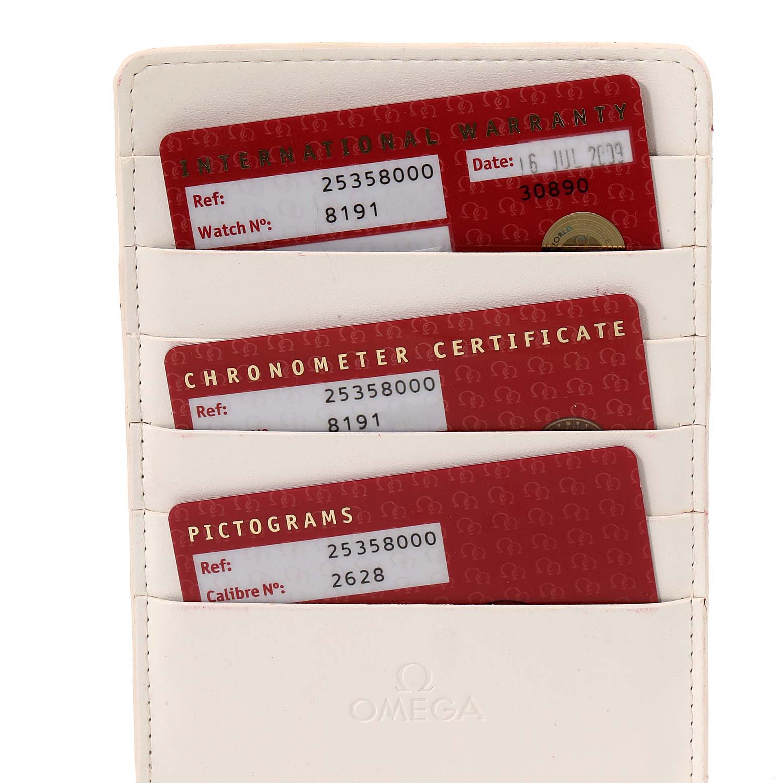 This image shows three Omega Seamaster 2535.80.00 Men's Stainless Steel Blue Dial 2535.80.00 Men's Stainless Steel Blue Dial watch cards: an International Warranty, a Chronometer Certificate, and a Pictograms card in a holder.