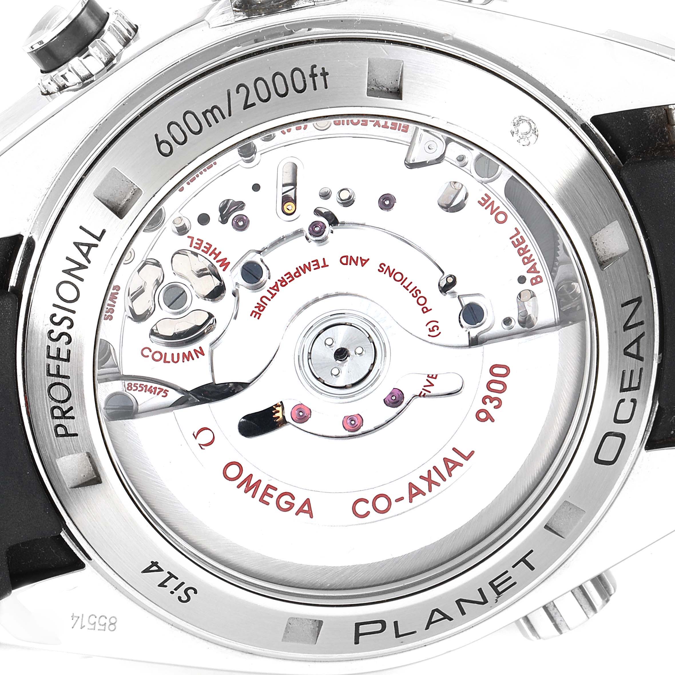 The image shows the back of an Omega Planet Ocean 232.32.46.51.01.003 Men
s Stainless Steel Black Dial 232.32.46.51.01.003 Men
s Stainless Steel Black Dial watch, highlighting its internal mechanics and "600m/2000ft" depth rating.