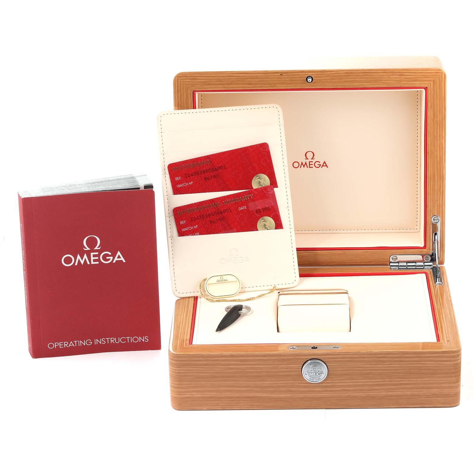 The image shows the Omega Speedmaster 324.30.38.50.06.001 Men's Stainless Steel Grey Dial 324.30.38.50.06.001 Men's Stainless Steel Grey Dial box set with operating instructions, red cards, and a key.