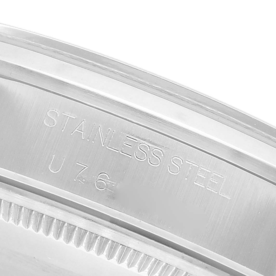 This close-up image shows the stainless steel case back and part of the bezel of a Rolex Air-King 14000 Men's Stainless Steel Blue Dial 14000 Men's Stainless Steel Blue Dial watch.