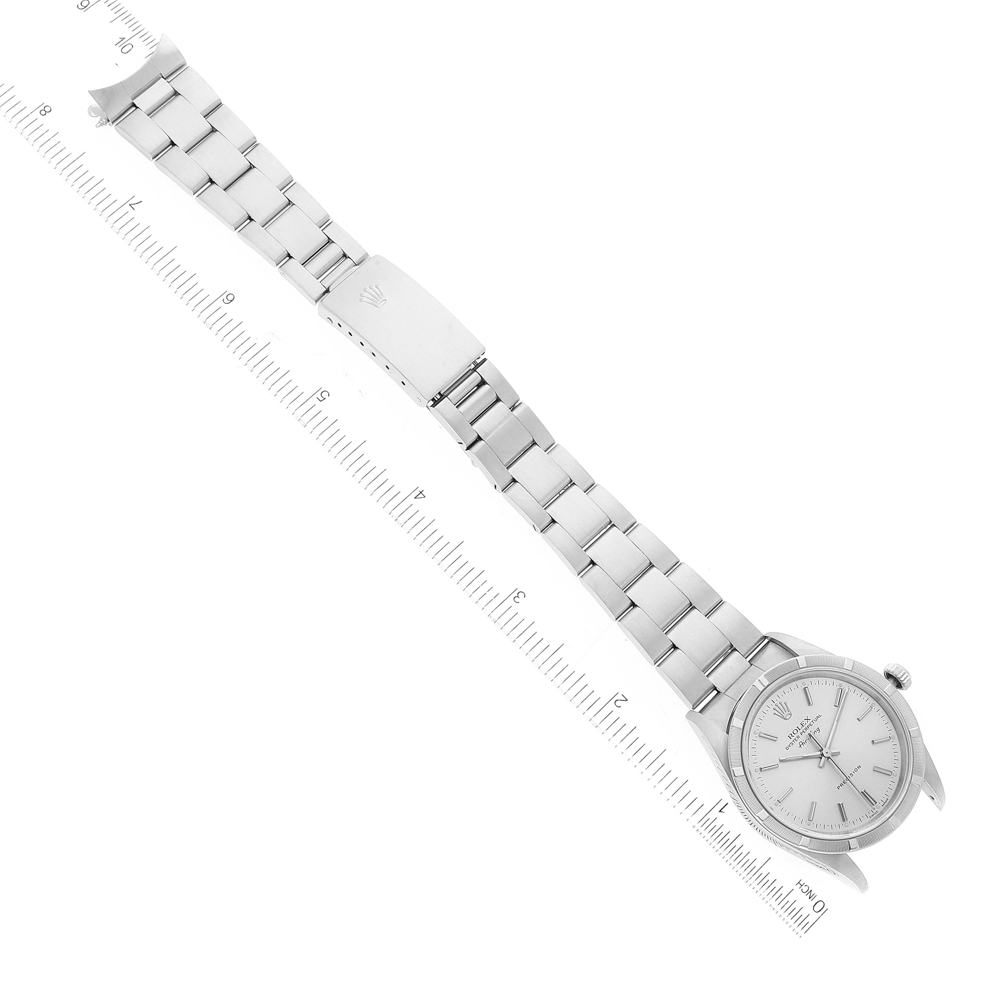 The Rolex Air-King 14010 Men's Stainless Steel Silver Dial 14010 Men's Stainless Steel Silver Dial watch is shown from a top-down angle, displaying its full stainless steel band and face alongside a ruler for scale.