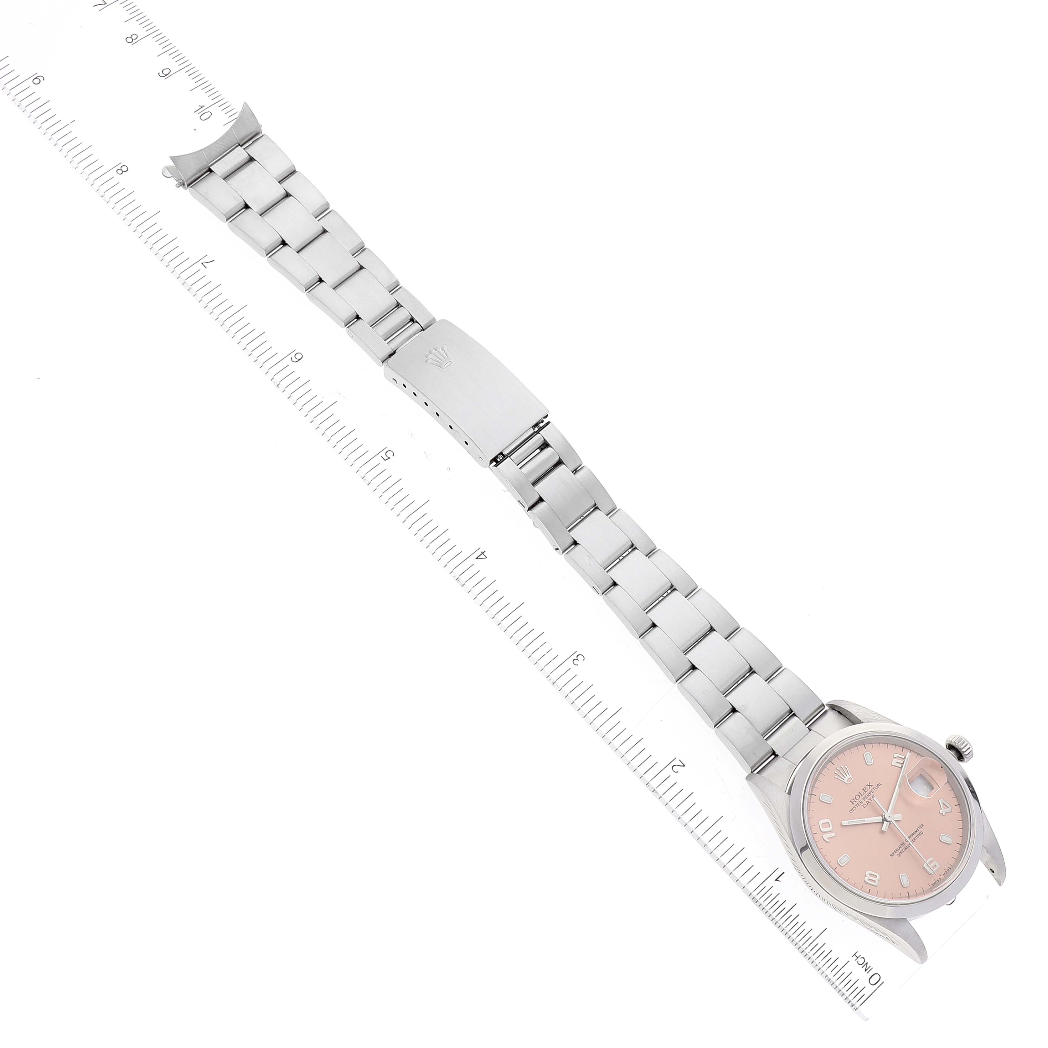 The Rolex Date 15200 Men
s Stainless Steel Pink Dial 15200 Men
s Stainless Steel Pink Dial model watch is shown from an overhead angle, displaying the bracelet, clasp, case, and dial with rulers beside it.