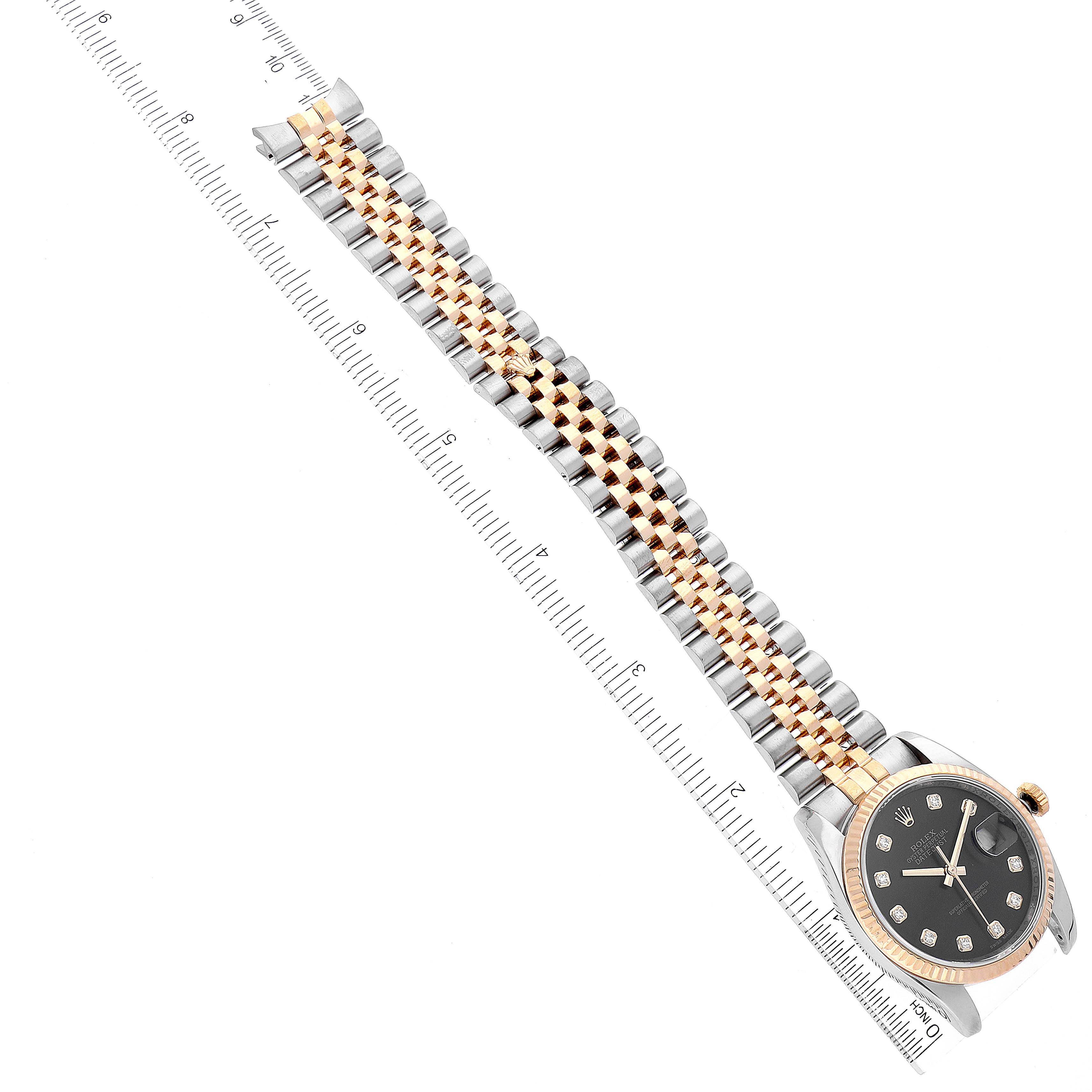 The image shows a Rolex Datejust 116233 Men's Steel and Gold (two tone) Black Dial 116233 Men's Steel and Gold (two tone) Black Dial watch at a diagonal angle, displaying the dial, bezel, and two-tone Jubilee bracelet next to a ruler.