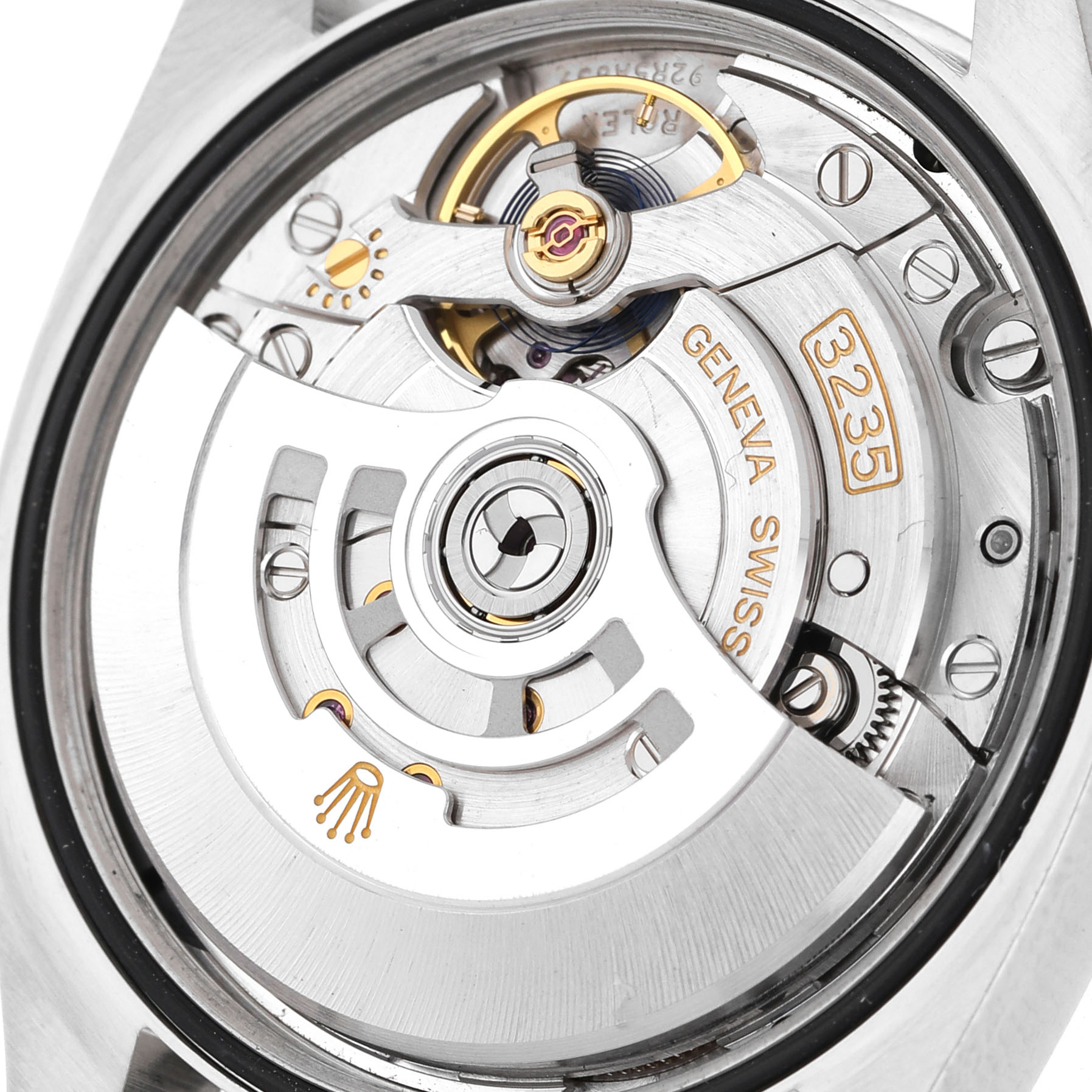 The image shows the movement of a Rolex Datejust 126200 Men's Stainless Steel Black Dial, highlighting the intricate gears and rotor from the back angle.