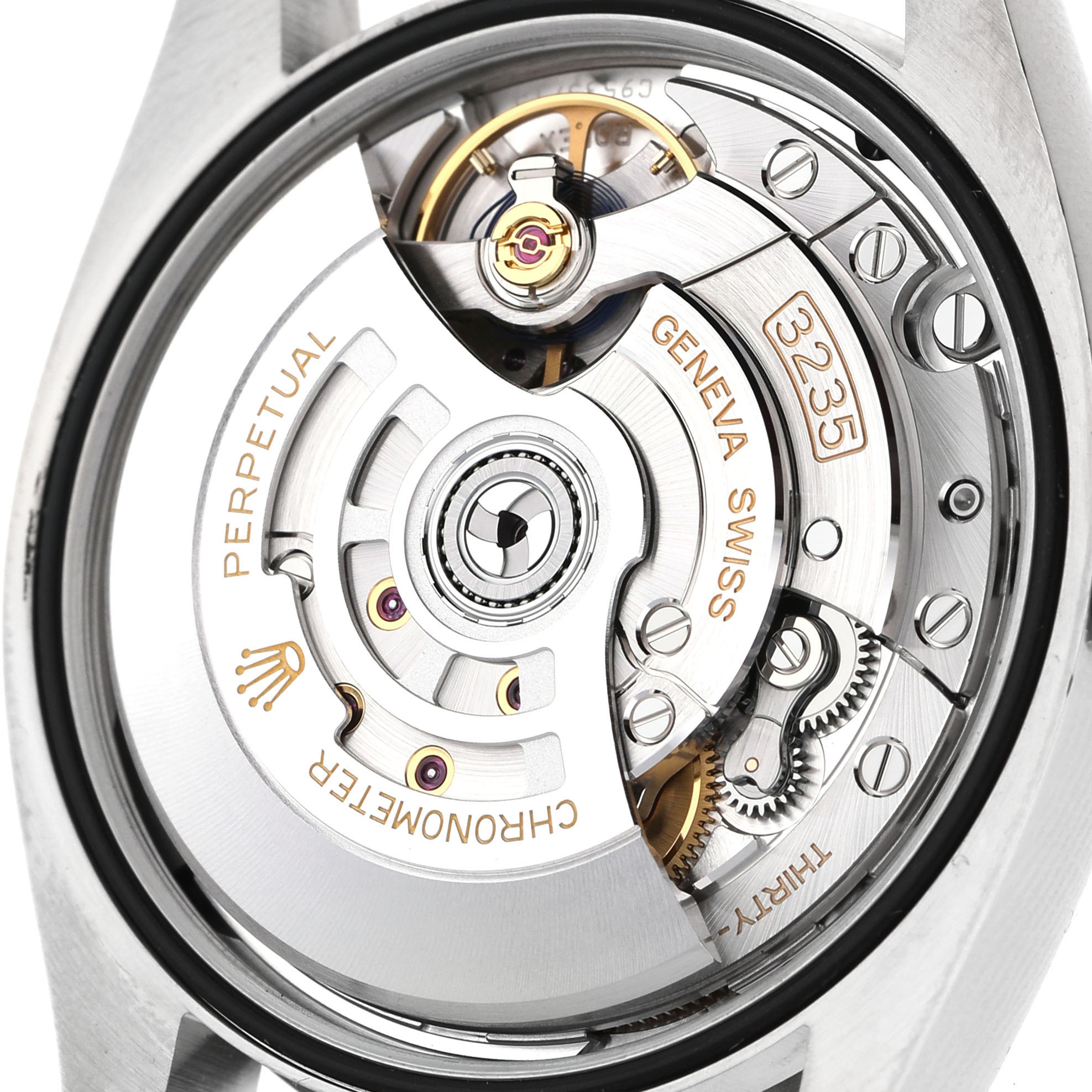 The image shows the movement of a Rolex Datejust 126200 Men's Stainless Steel Silver Dial, focusing on its intricate interior components from a rear angle.
