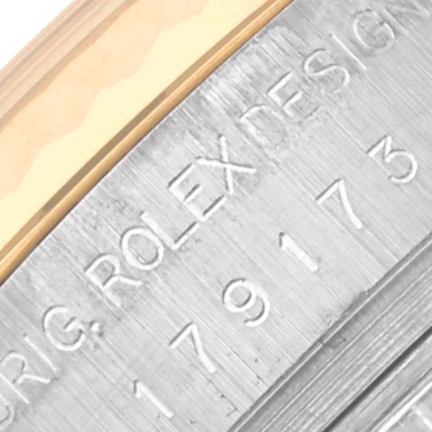 The image shows a close-up of the Rolex Datejust 179173 Women's Steel and Gold (two tone) Champagne Dial 179173 Women's Steel and Gold (two tone) Champagne Dial's side, highlighting design engraving details.