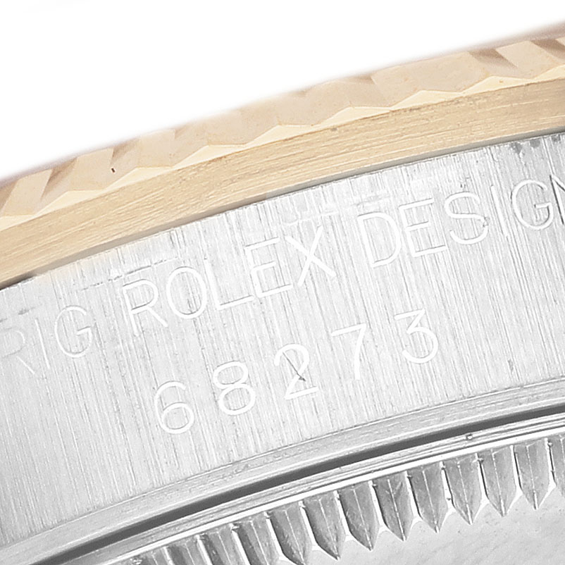 The image shows a close-up of the engraved case side and fluted bezel of a Rolex Datejust 68273 Women's Stainless Steel Champagne Dial watch.