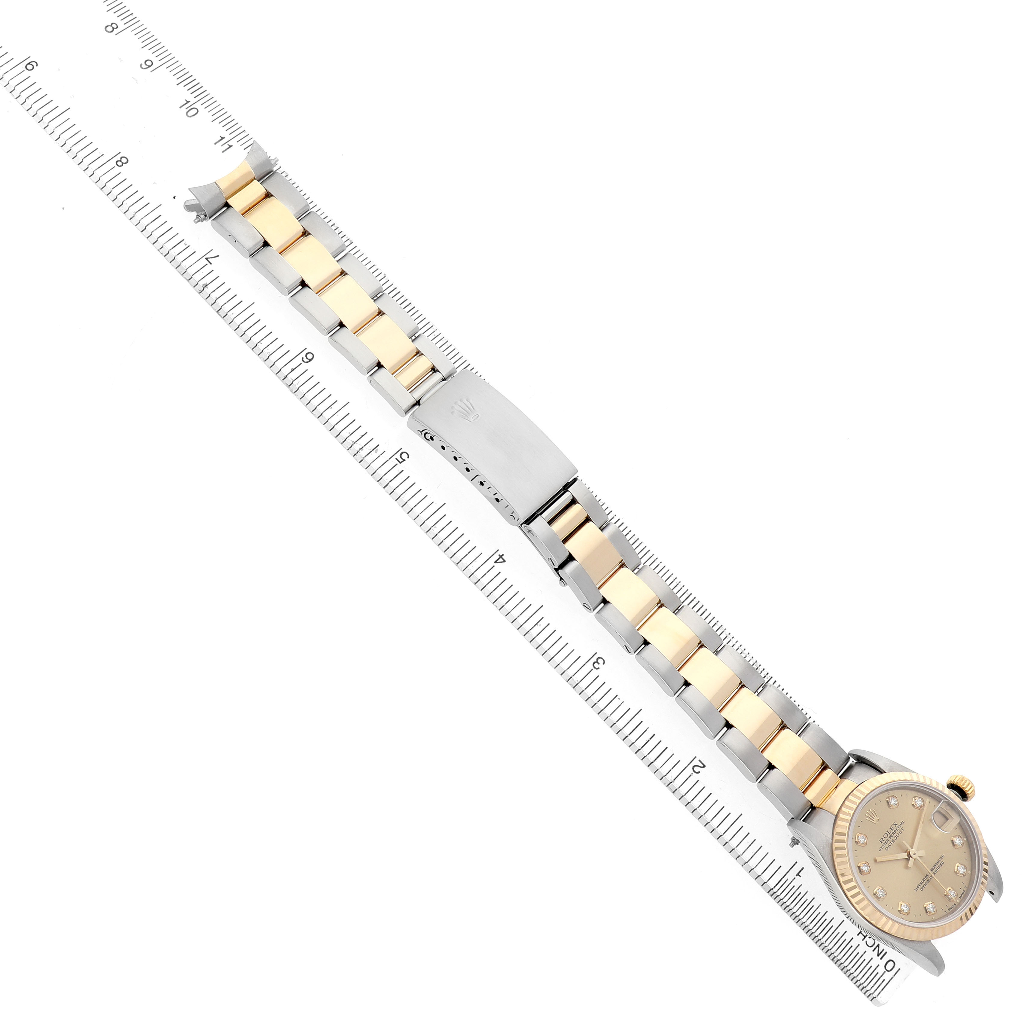 The Rolex Datejust 68273 Women's Stainless Steel Champagne Dial watch is displayed at an angled top view, showing the face, dial, and entire bracelet, alongside a ruler for scale.