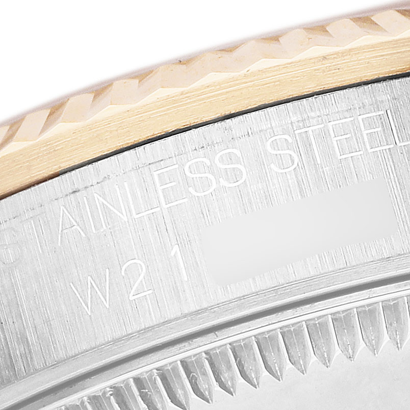 The image shows a close-up of the side of a Rolex Datejust 68273 Women's Stainless Steel Champagne Dial watch, highlighting the bezel and part of the engraved text.