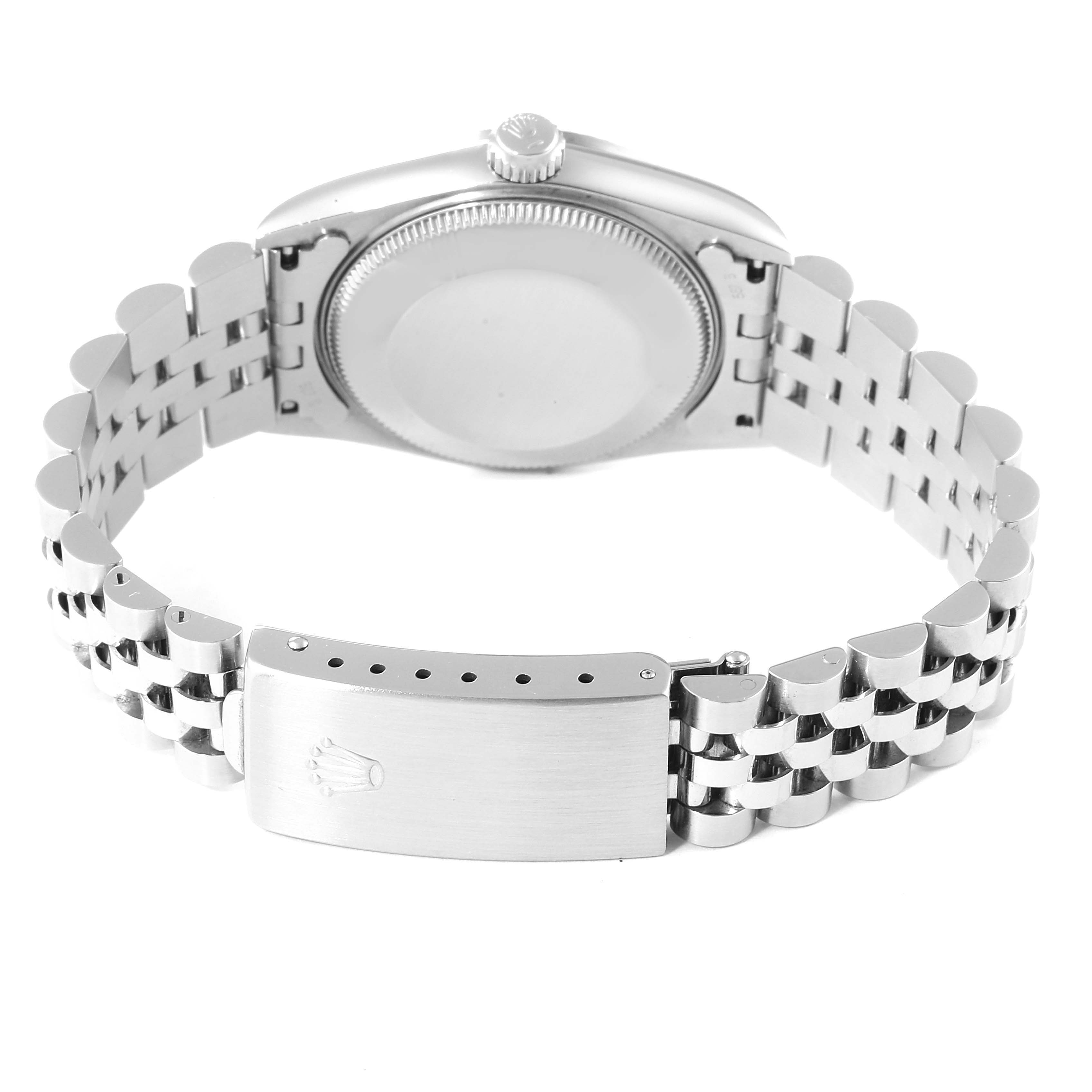 The image shows the back and clasp of a Mid-Size Rolex watch, with the bracelet laid open.