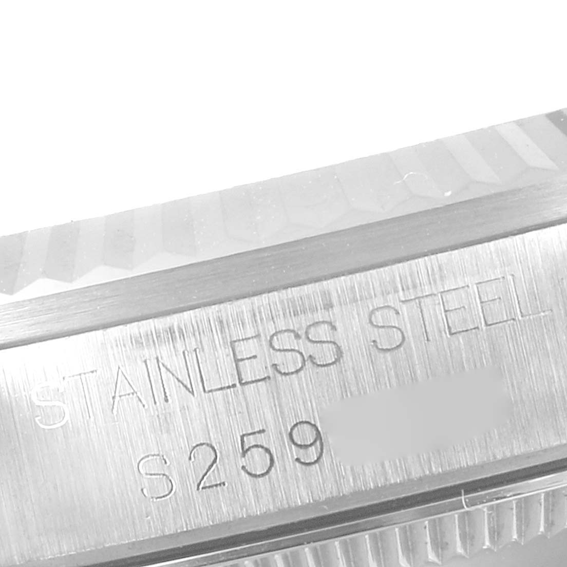 The image shows a close-up of the side engraving on a stainless steel Mid-Size Rolex watch case.