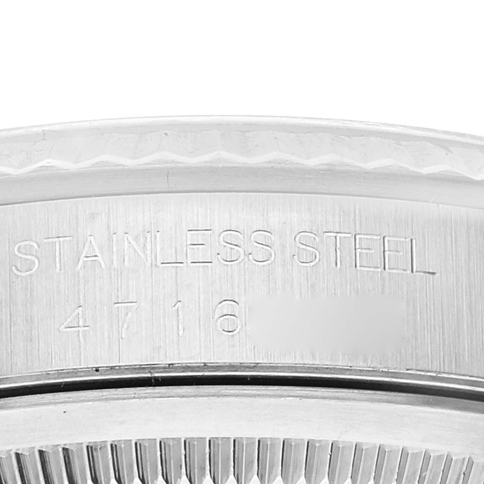 This image shows a close-up of the serial number area on the back case of a Rolex Datejust 16234 Men's Stainless Steel Black Dial 16234 Men's Stainless Steel Black Dial watch, highlighting "STAINLESS STEEL."