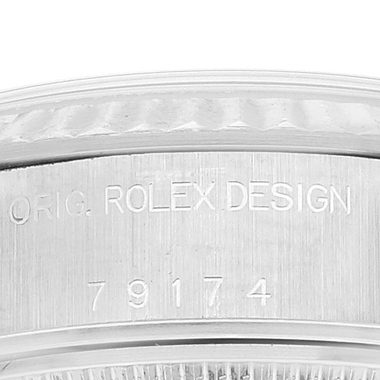This image shows an engraved side part of the bezel on a Rolex Datejust 79174 Women's Stainless Steel Silver Dial 79174 Women's Stainless Steel Silver Dial watch with the model number 79174.