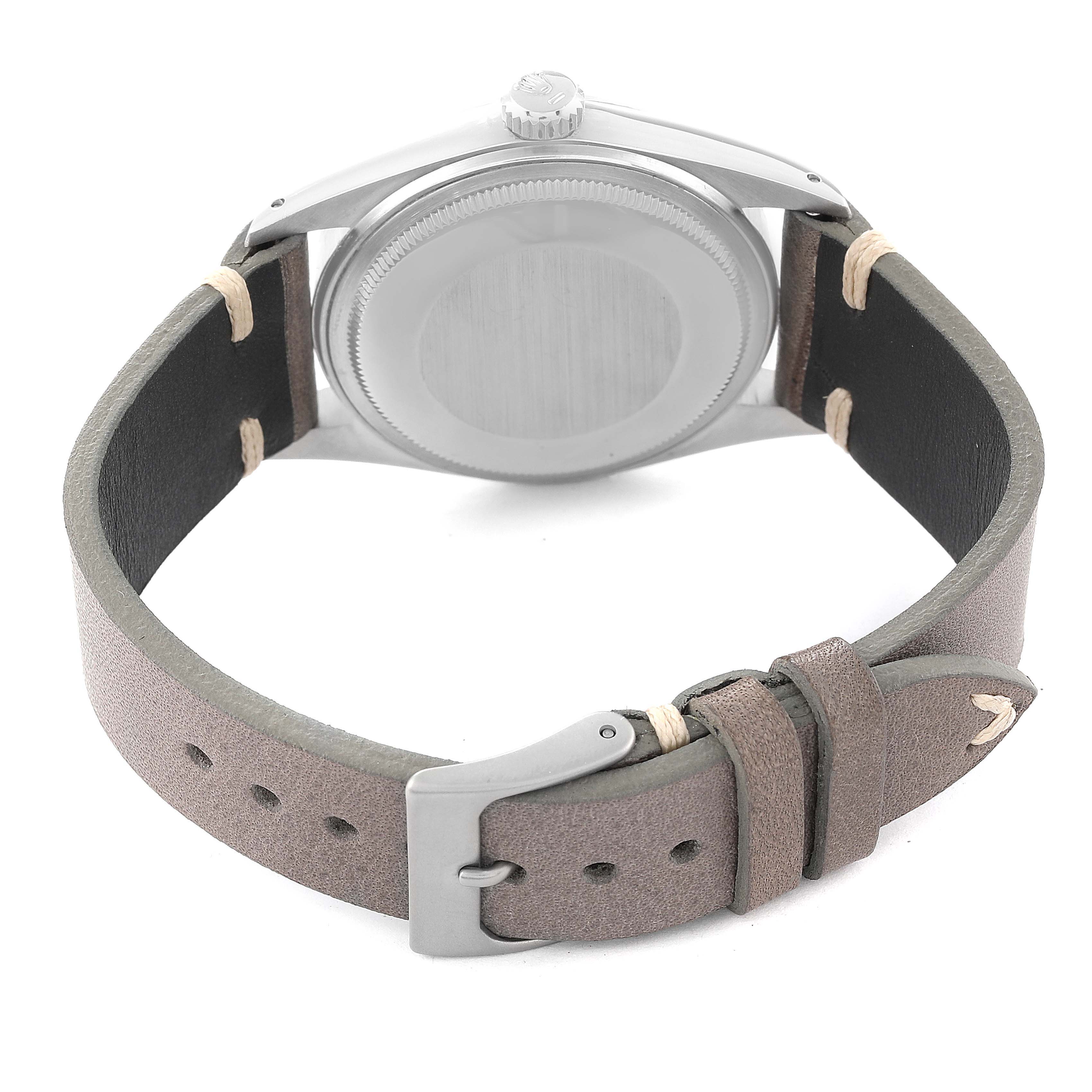 The image shows the back of a Rolex Datejust 16014 Men's Steel and Gold (two tone) Silver Dial 16014 Men's Steel and Gold (two tone) Silver Dial, highlighting the case back and leather strap with a buckle.