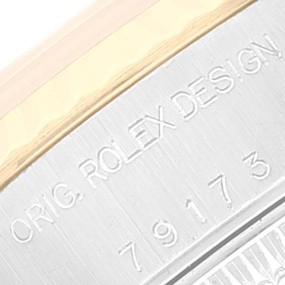 The image shows a close-up of the engraved details on the side of a Rolex Datejust 79173 Women
s Steel and Gold (two tone) Black Dial 79173 Women
s Steel and Gold (two tone) Black Dial watch case, including its model number.