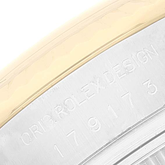 This close-up image shows the engraved case back and the edge of the bezel of a Rolex Datejust 179173 Women's Steel and Gold (two tone) Mother of Pearl Dial 179173 Women's Steel and Gold (two tone) Mother of Pearl Dial watch.