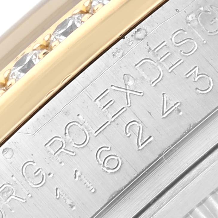 This image shows a close-up of the edge and engraved bezel details on a Rolex Datejust 116243 Men's Steel and Gold (two tone) Mother of Pearl Dial 116243 Men's Steel and Gold (two tone) Mother of Pearl Dial watch.