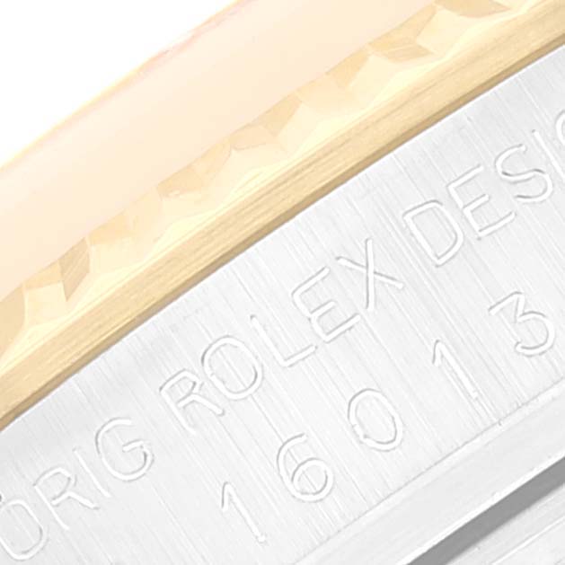 This image shows a close-up of the bezel and engraved case side of a Rolex Datejust 16013 Men's Steel and Gold (two tone) Beige Dial 16013 Men's Steel and Gold (two tone) Beige Dial watch.