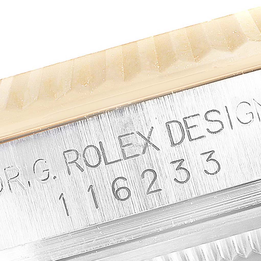 The image shows a close-up view of the case side, serial number, and bezel of a Rolex Datejust 116233 Men's Steel and Gold (two tone) Grey Dial 116233 Men's Steel and Gold (two tone) Grey Dial watch.